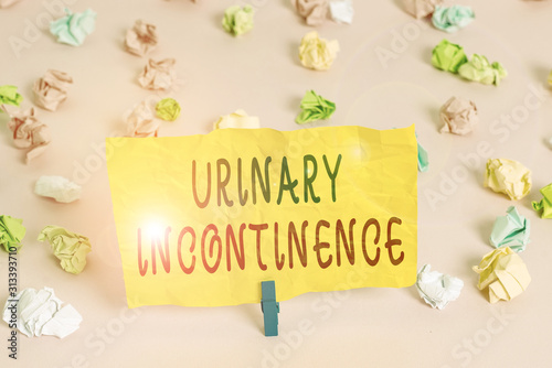 Handwriting text writing Urinary Incontinence. Conceptual photo uncontrolled leakage of urine Loss of bladder control Colored crumpled papers empty reminder pink floor background clothespin © Artur