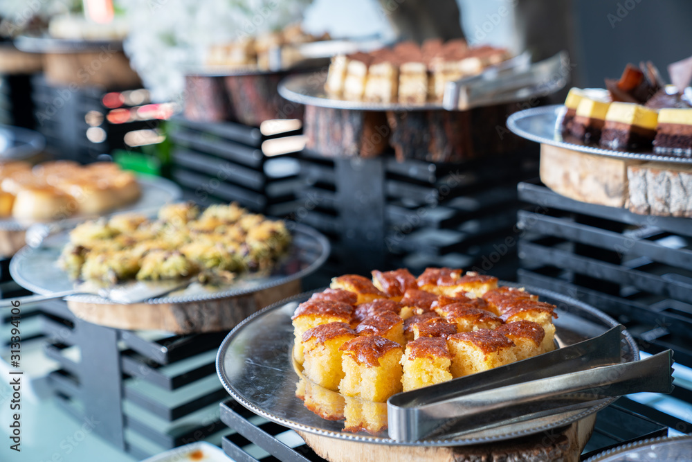 A delicious dessert buffet with various sweet bakery in a restaurant or hotel A delicious dessert buffet with various sweet bakery in a restaurant or hotel