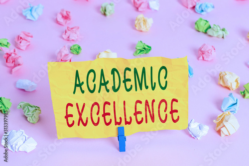 Handwriting text writing Academic Excellence. Conceptual photo Achieving high grades and superior perforanalysisce Colored crumpled papers empty reminder pink floor background clothespin © Artur
