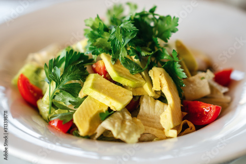 A delicious avocado salad is served in a elegance restaurant or hotel