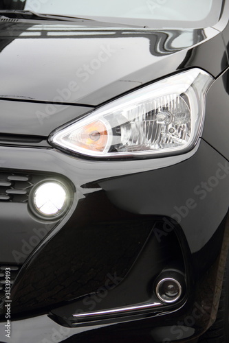 a modern car headlight with daytime running lights on a car