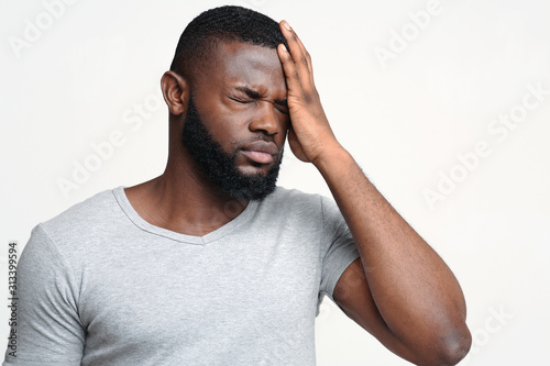 Young tired afro man having mental problem photo