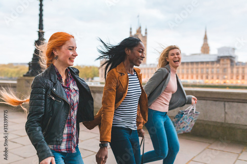 Photography Happy women having fun after shopping in London