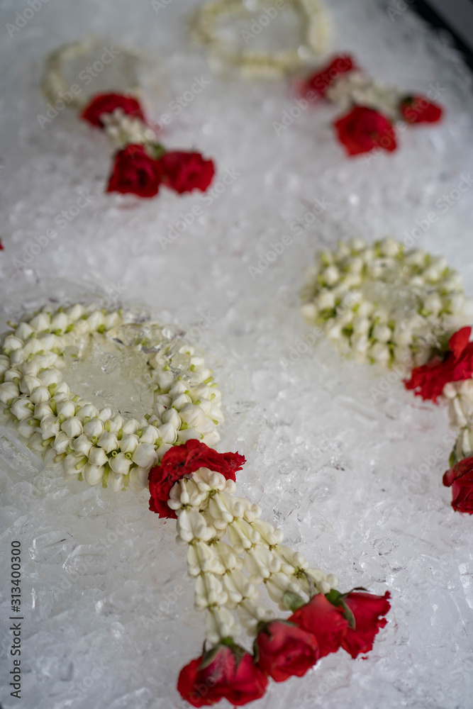 Beautiful garland on ice cubes are for sale at market in Thailand