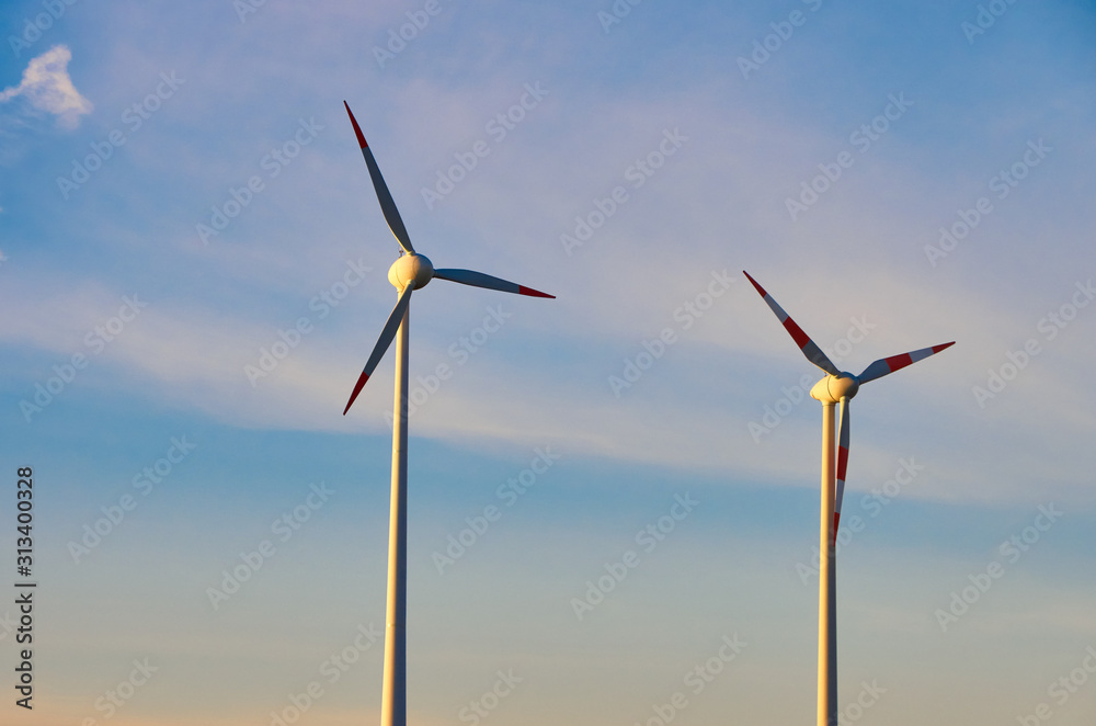 two wind generators against the sky