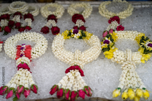 Beautiful garland on ice cubes are for sale at market in Thailand