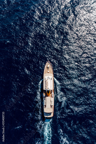 Aerial vertical shot of a boat sailing on the sea © SPIX PRODUCTION