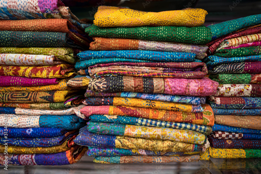 Stack of textured fabric for sale in market. Stack of textured fabric for sale in market.