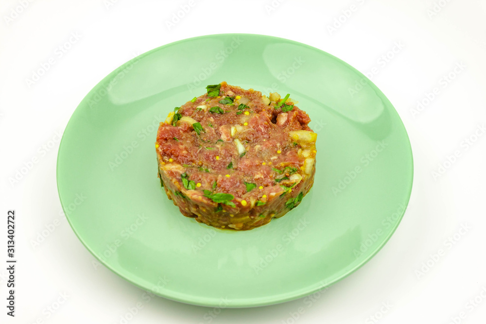 Beef Tartare cold appetizer of raw minced meat with egg yolk, spices, onions, olive oil, lemon juice Beef Tartare cold appetizer of raw minced meat with egg yolk, spices, onions, olive oil, lemon juice