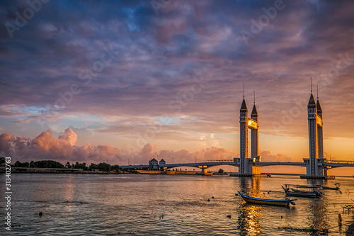 Beautiful Terengganu Draw Bridge  during sunrise. The newly minted bridge provides road connection between the mainland Kuala Terengganu  and Seberang Takir. Image contains excessive noise photo