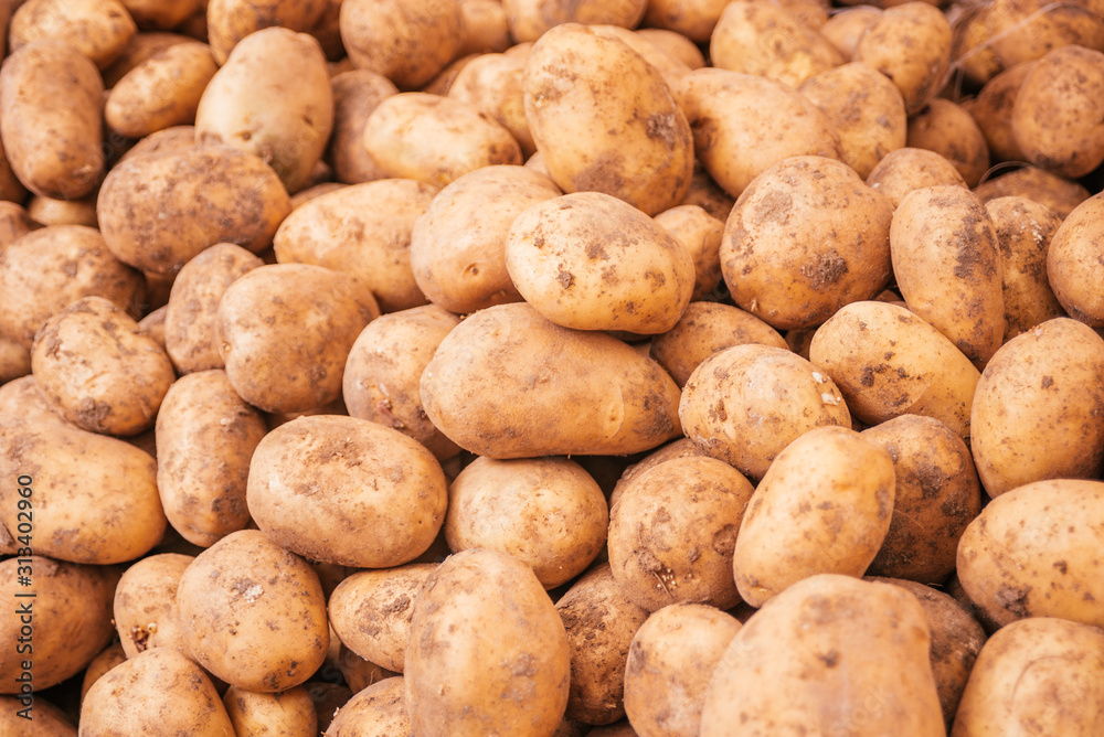 Beautiful selected organic potatoes background, lots of potatoes on a market counter. Beautiful selected organic potatoes background, lots of potatoes on a market counter.