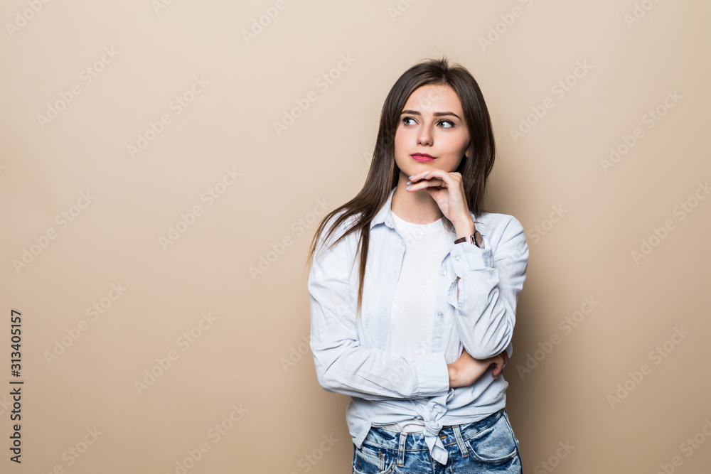 Young woman thinking isolated on beige background Young woman thinking isolated on beige background