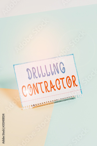 Text sign showing Drilling Contractor. Business photo showcasing contract their services mainly for drilling wells Paper placed tilted above buffer wire on soft pastel multi colours backdrop photo