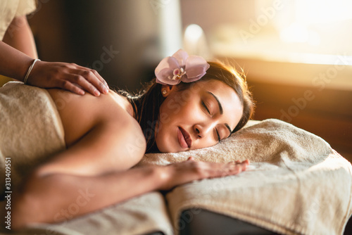 Happiness on woman's face having relaxing thai massage