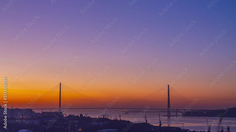 Time lapse of the cityscape overlooking the Russian bridge at dawn. Vladivostok, Russia Time lapse of the cityscape overlooking the Russian bridge at dawn. Vladivostok, Russia