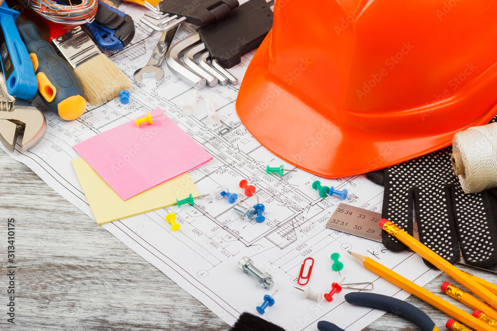 Set of different construction tools and a helmet, wooden background Set of different construction tools and a helmet, wooden background