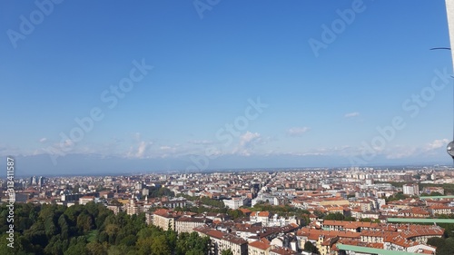 Turin, Italy - 01/004/2019: Beautiful panoramic view from Mole Antoneliana to the city of Turin in winter days with clear blue sky and the alps in the background. 