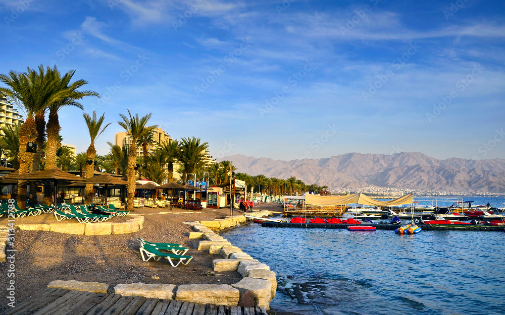 Relaxing atmosphere at the central public beach in Eilat - famous tourist resort and recreational city in Israel 