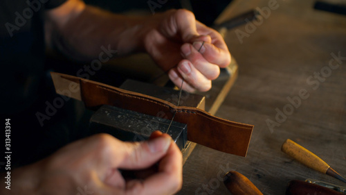 Tanner working with leather. photo