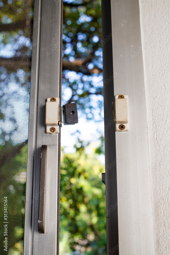 Broken security magnetic lock contact for mosquito wire screen window, Repair Room concept