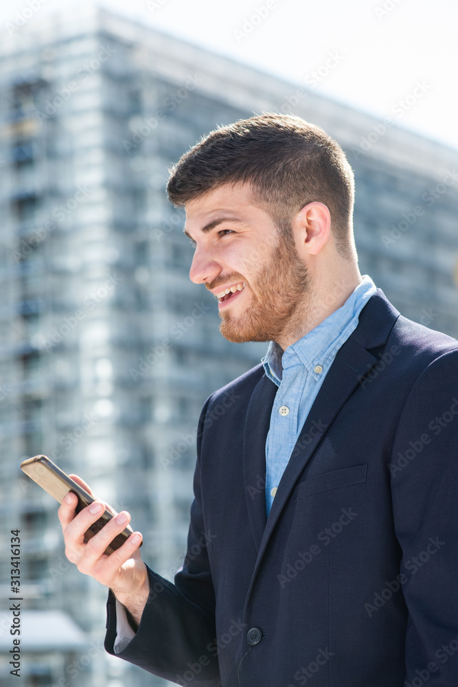 Side of businessman smiling with mobile phone in city Side of businessman smiling with mobile phone in city
