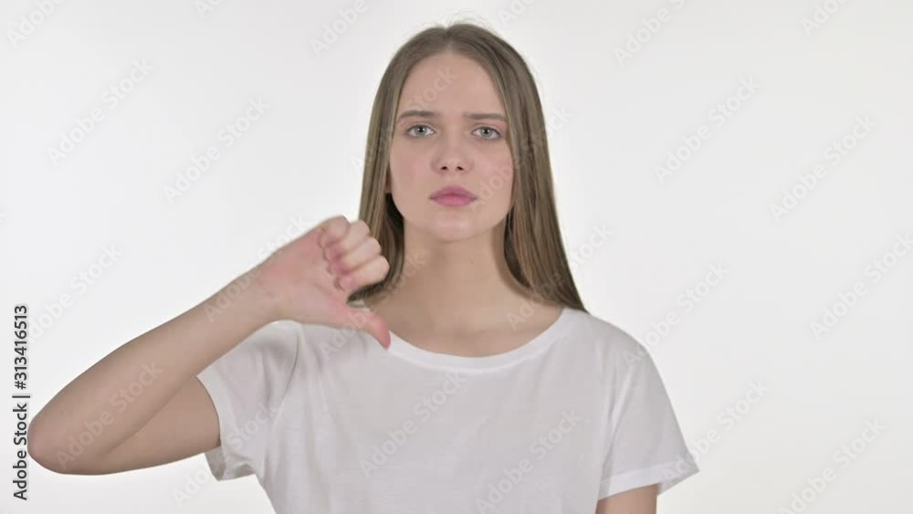 Thumbs Down by Beautiful Young Woman, White Background Thumbs Down by Beautiful Young Woman, White Background