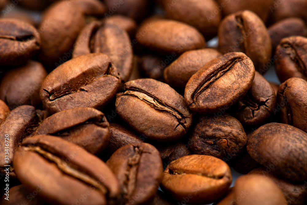 Naklejka premium Coffee beans close-up background. Fresh roasted