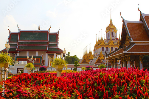 Red flowers in front of the golden metal castle
