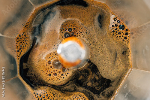 Process of brewing coffee in a moka pot, close-up, top view photo