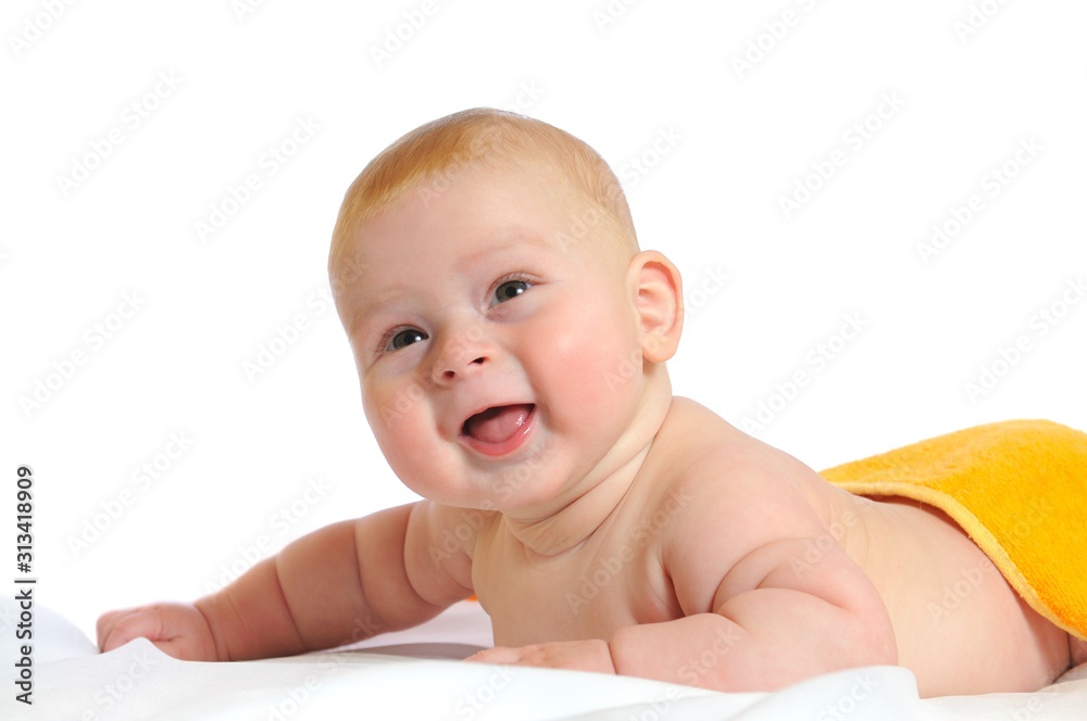 Cute baby lies under yellow blanket Cute baby lies under yellow blanket