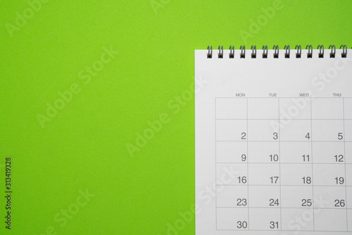 close up of calendar on the green table, planning for business meeting or travel planning concept