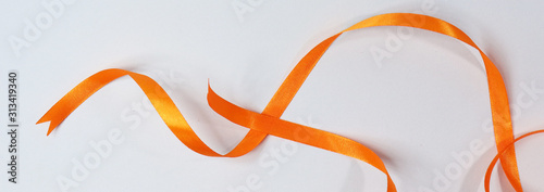 Orange ribbon isolated on white background