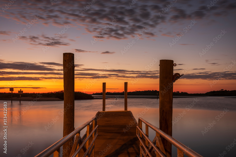 A motion-blur image of a boat launch, located in Daytona Beach, Florida at sunrise on the Halifax River. 