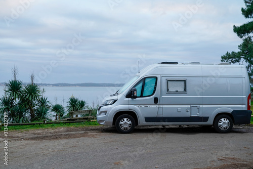 campervan rv parked on seaside in winter sunrise vanlife day in french coast in cap ferret village france