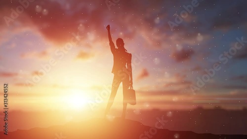 silhouette of a girl, a business woman on a background of a beautiful, golden sunset. The concept of inspiration, enthusiasm, startup, feminism