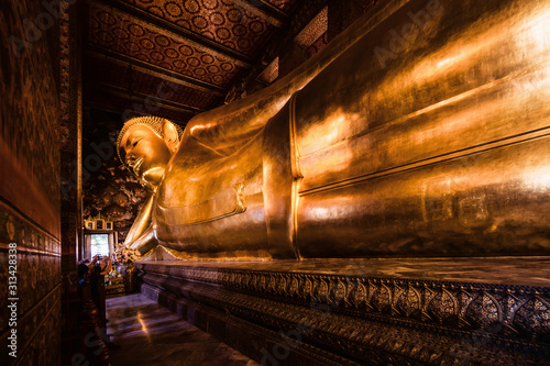 famous golden reclining buddha statue at wat pho bangkok thailand photo