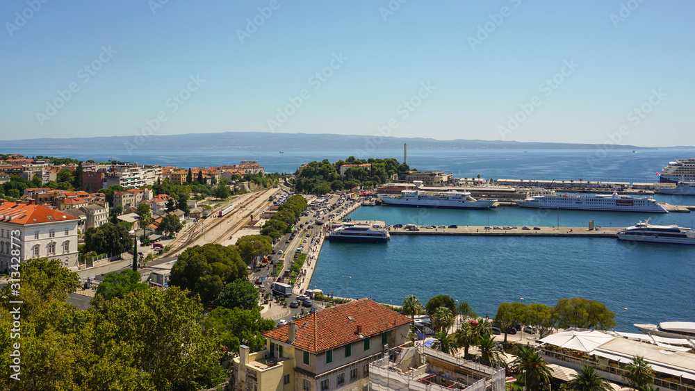 View of the southern part of Split from the bell tower of the Split Palace. Port, moorings, promenade, ships, railway station, tram tracks, island of Brac