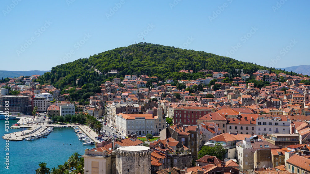 View of the western part of Split from the bell tower of the Split Palace. Harbor, palm trees, promenade, Riva, cityscape, bay, coast