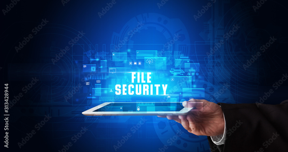 Young business person working on tablet and shows the digital sign: FILE SECURITY Young business person working on tablet and shows the digital sign: FILE SECURITY