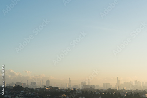 Far view of Kuala Lumpur city skyline in hazy and misty morning
