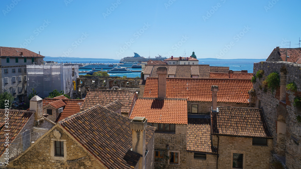 View of the southern part of Split from the bell tower of the Split Palace. Roofs of houses from a tile, port, ships, island of Brac are visible