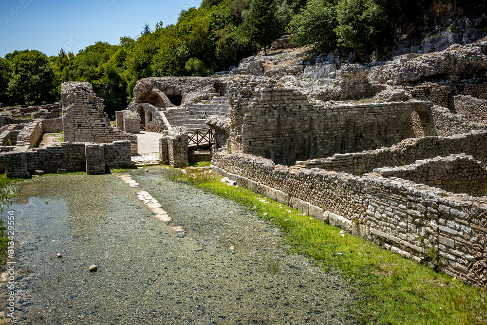 Central palace building ruins. Beautiful warm spring day and archeological ruins at Butrint National Park, Albania, UNESCO heritage. Travel photography with fresh green flora