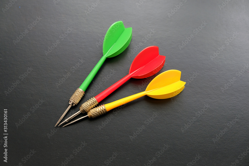 red, yellow, green dart arrows on black background, red, yellow, green dart arrows on black background,