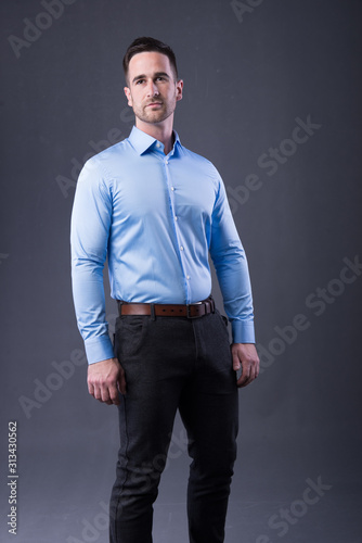 young man in a blu shirt and dress pants