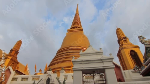 Camera pans along a beautiful golden stupas in Buddhist temple in Bangkok, Thailand. (ID: 313430938)