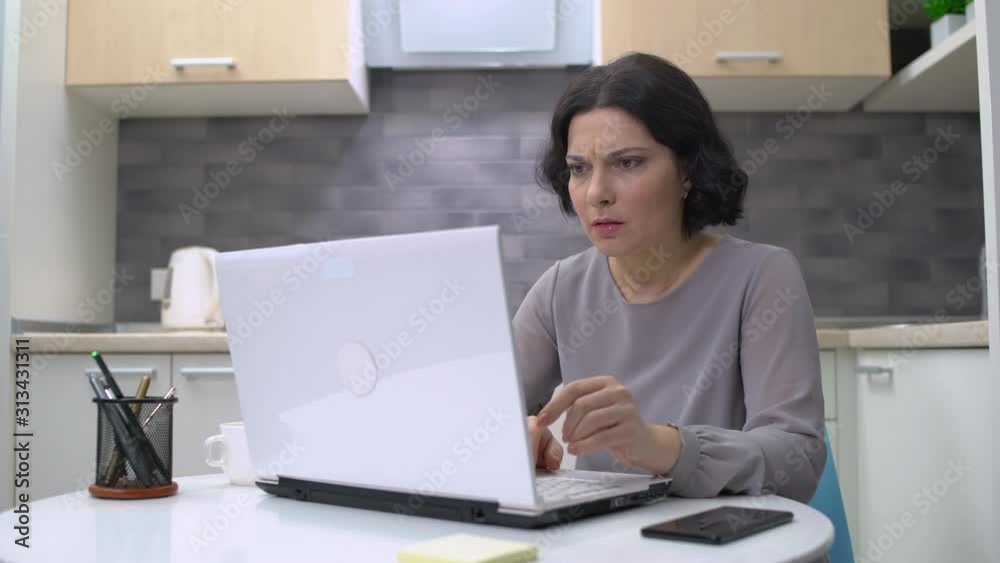 Shocked woman reading message on laptop, got fired, problems, disappointment
