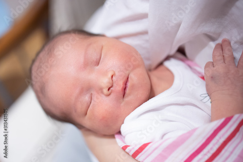 Sleeping newborn baby on Mother Hand