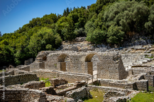 Central palace building ruins. Beautiful warm spring day and archeological ruins at Butrint National Park, Albania, UNESCO heritage. Travel photography with fresh green flora photo