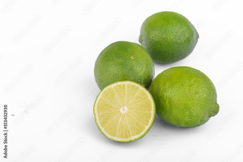 Fresh lime, half and quarter part on white background. Green citrus fruit. Fresh lime, half and quarter part on white background. Green citrus fruit.
