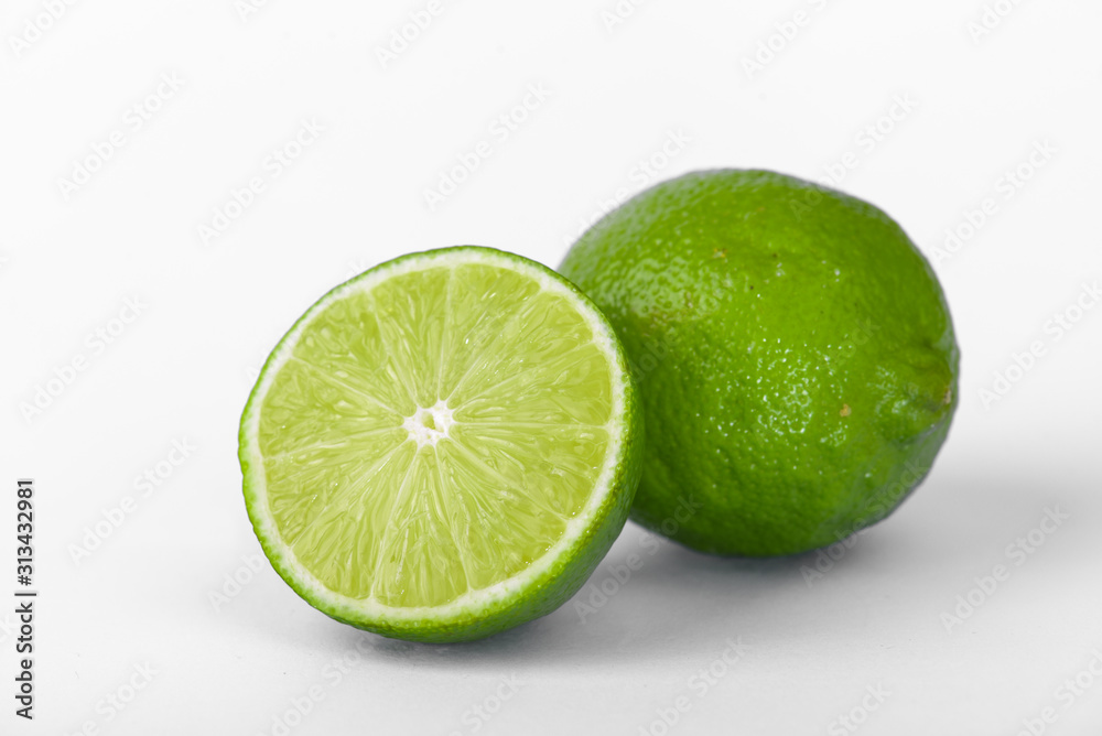 Fresh lime, half and quarter part on white background. Green citrus fruit. Fresh lime, half and quarter part on white background. Green citrus fruit.